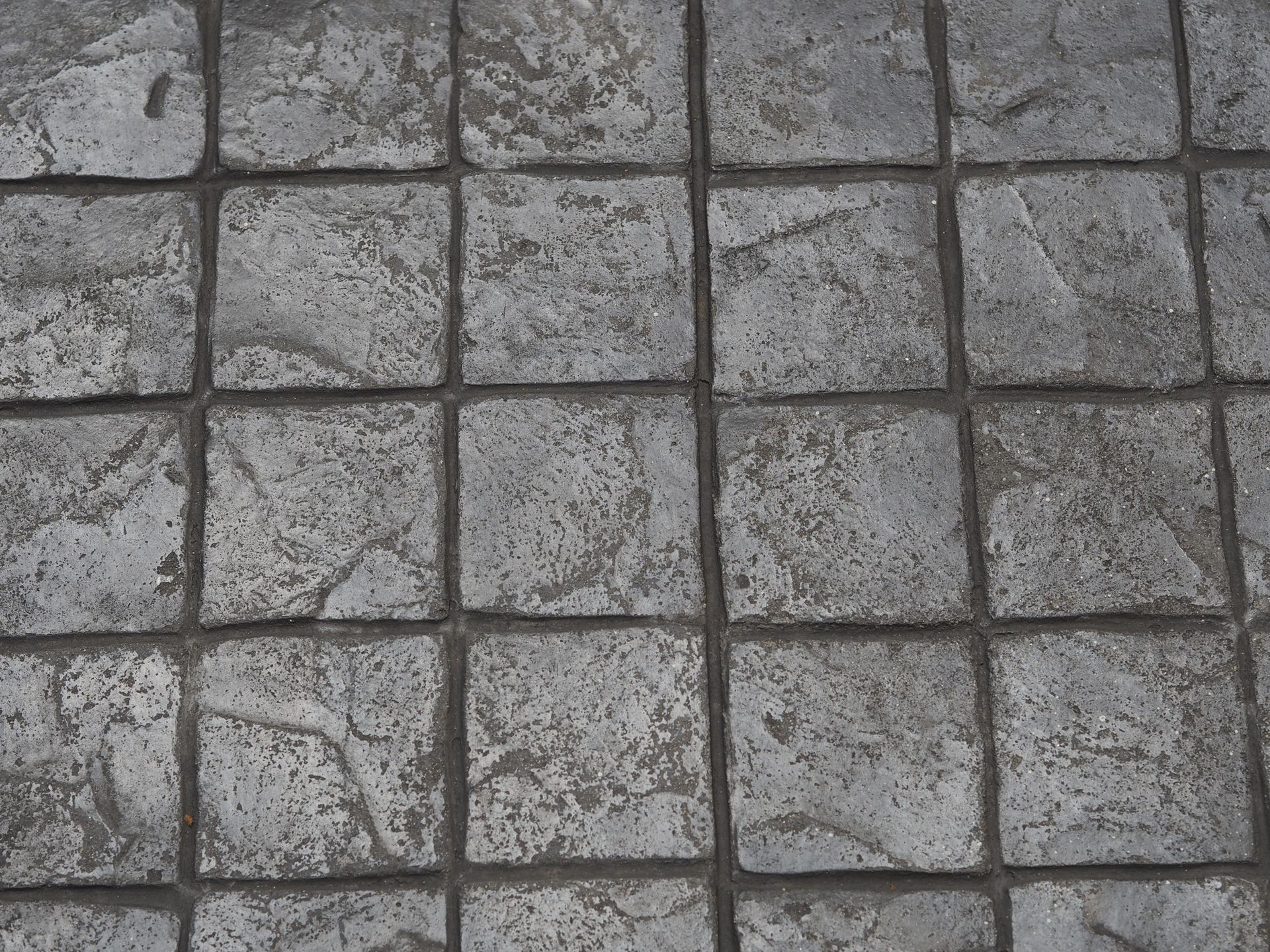 Stamp concrete patio in Centerville, NJ creates unique patterns on surfaces using colors such as black.