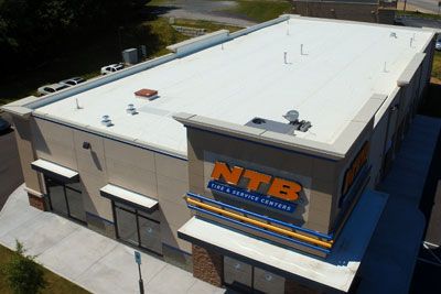 An aerial view of a ntb store with a white roof.