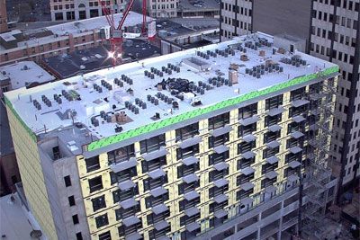 An aerial view of a building under construction in a city.