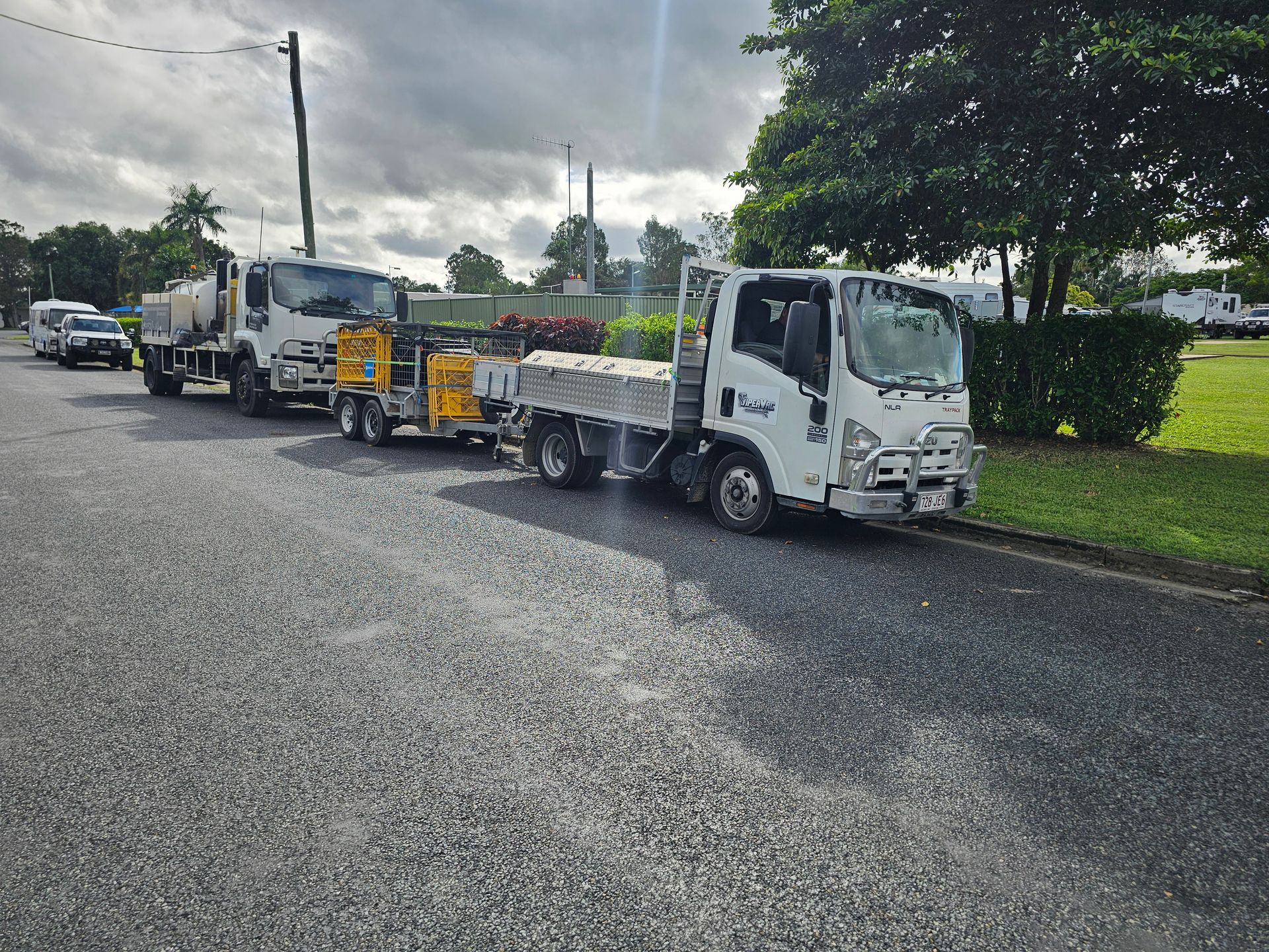 A Tow Truck Is Parked On The Side Of The Road Next To A Tree — ViperVac Solutions PTY LTD in Cannonvale, QLD
