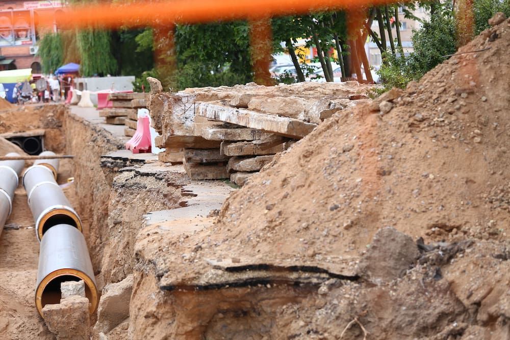 A Construction Site With A Bunch Of Pipes In The Dirt — ViperVac Solutions PTY LTD in Airlie Beach, QLD