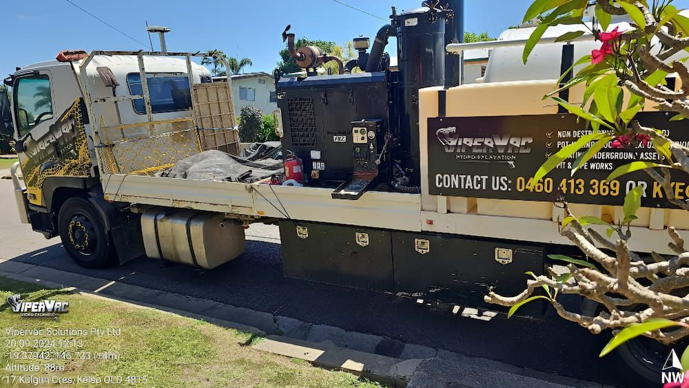 A Dock Leading To A Beach With Trees And Buildings — ViperVac Solutions PTY LTD in Townsville, QLD