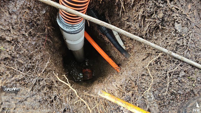 A Man In A Protective Suit Is Standing In Front Of A Pile Of Trash — ViperVac Solutions PTY LTD in Cannonvale, QLD