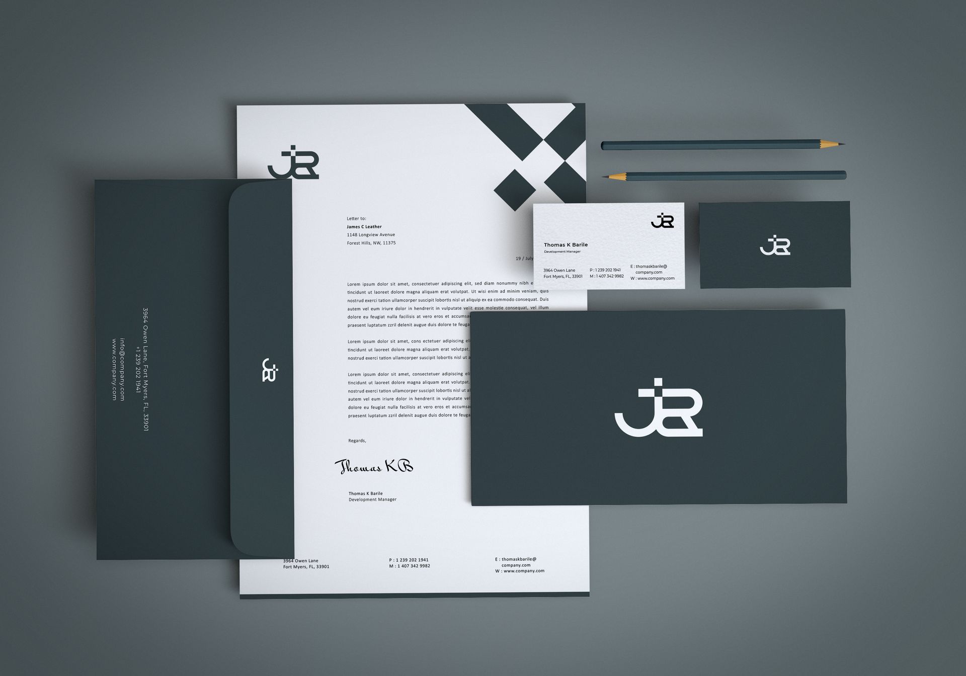 a mockup of a business card , letterhead , envelope , and pencil .