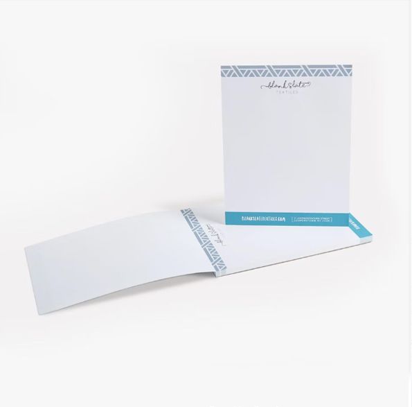 a white notepad with a blue border and a logo on it