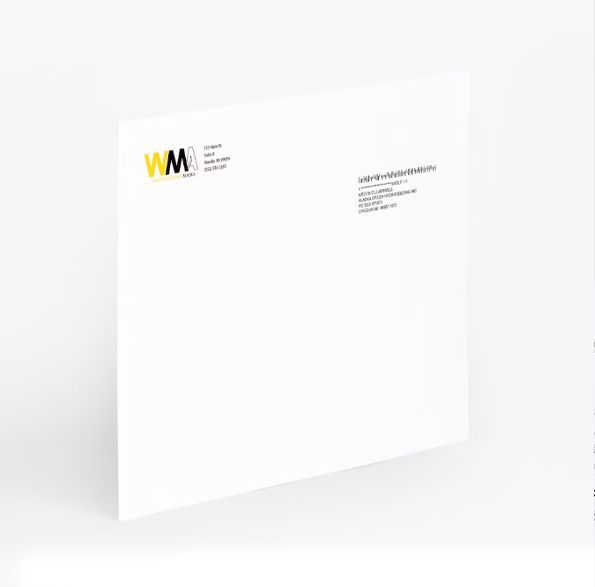 a white envelope with a yellow logo on it is sitting on a white surface .