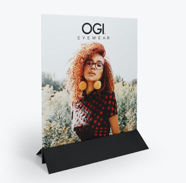 a picture of a woman wearing glasses is on a stand for ogi eyewear