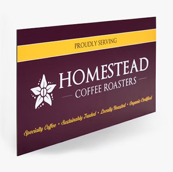 a sign for homestead coffee roasters proudly serving