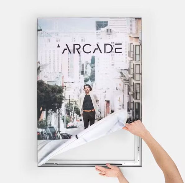 a person is holding a poster that says arcade on it