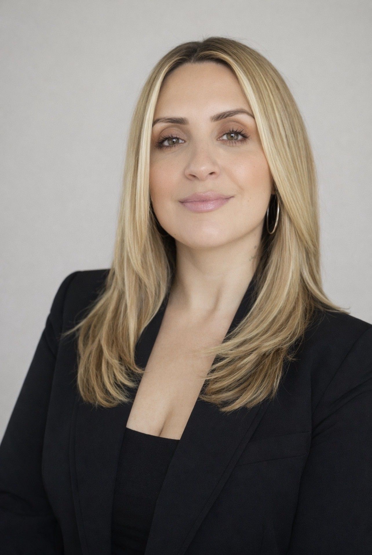 A man in a black shirt is smiling for the camera.