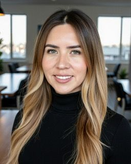 A man in a black shirt is smiling for the camera.
