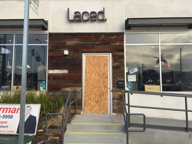 The front door of a laced store is boarded up