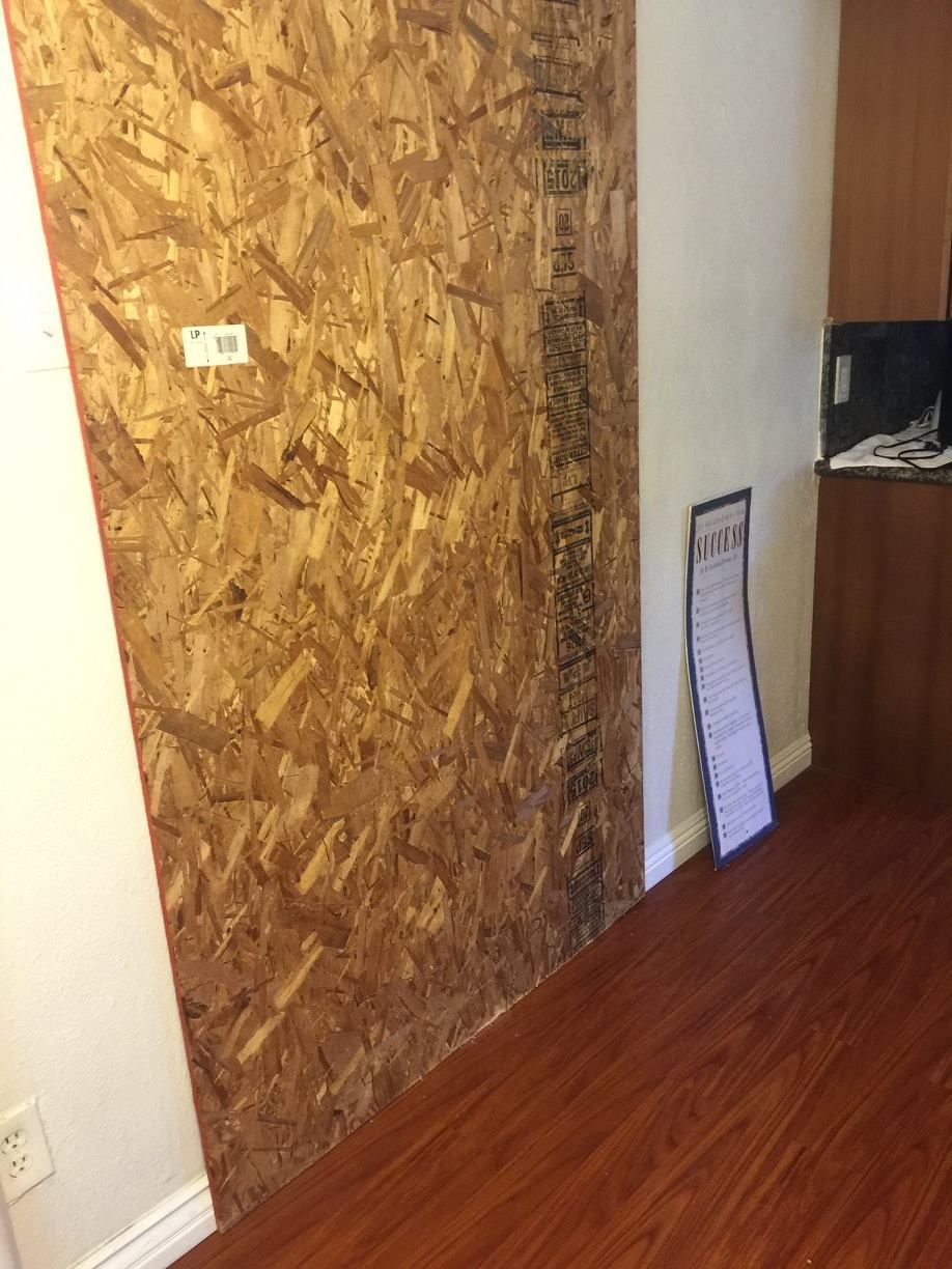 A room with a wooden floor and a wooden wall.