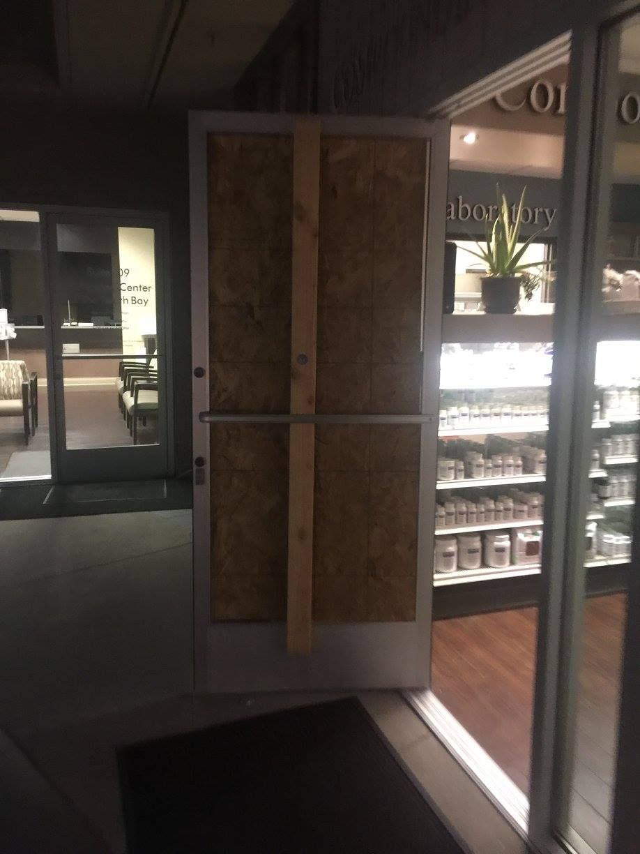 A door with a piece of plywood on it