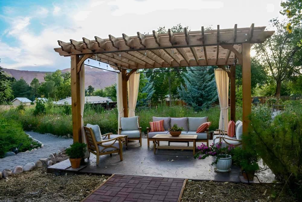 a Wooden Pergola With a Couch and Chairs Underneath It — D.J. Decks in Sapphire Beach, NSW