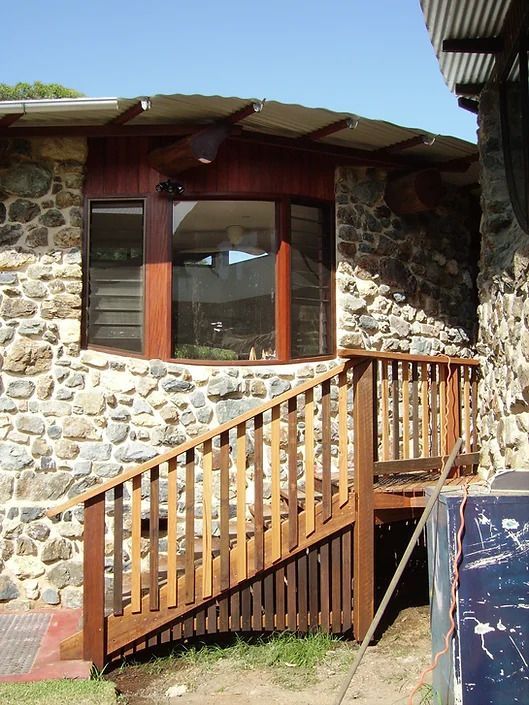 A Stone House With a Wooden Deck and Stairs — D.J. Decks in Woolgoolga, NSW