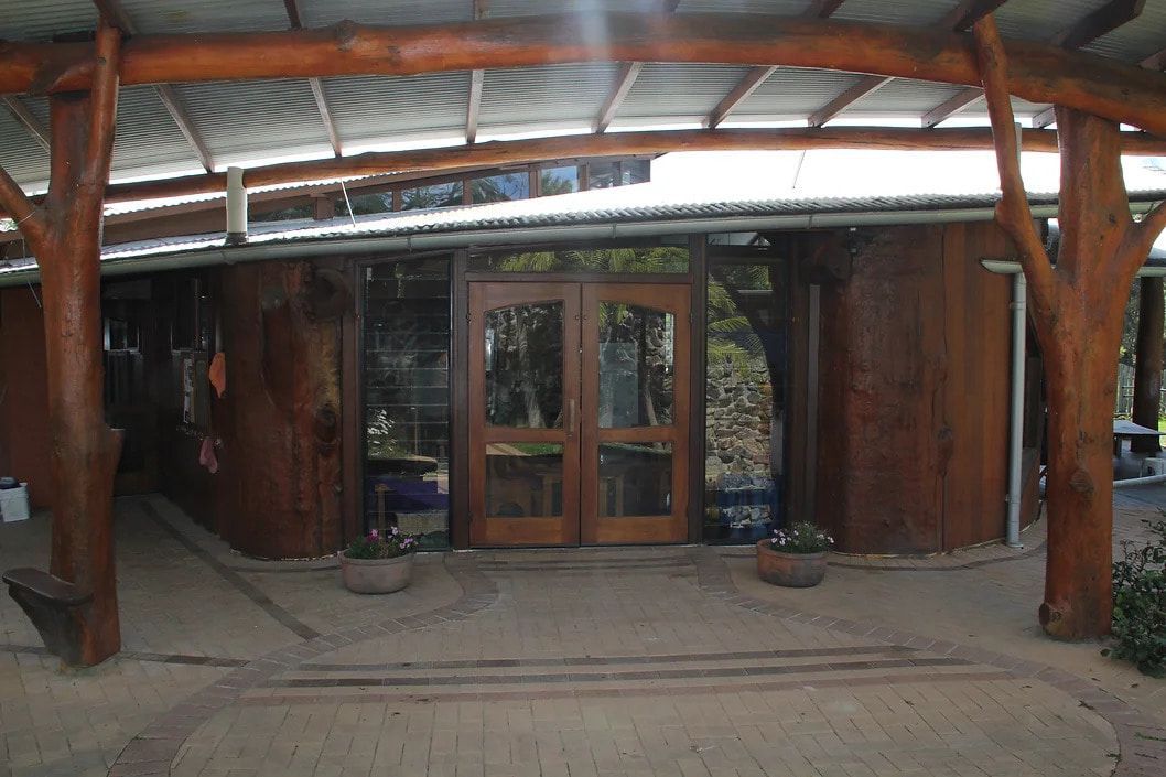 A Wooden Building With a Roof and a Door — D.J. Decks in Sapphire Beach, NSW