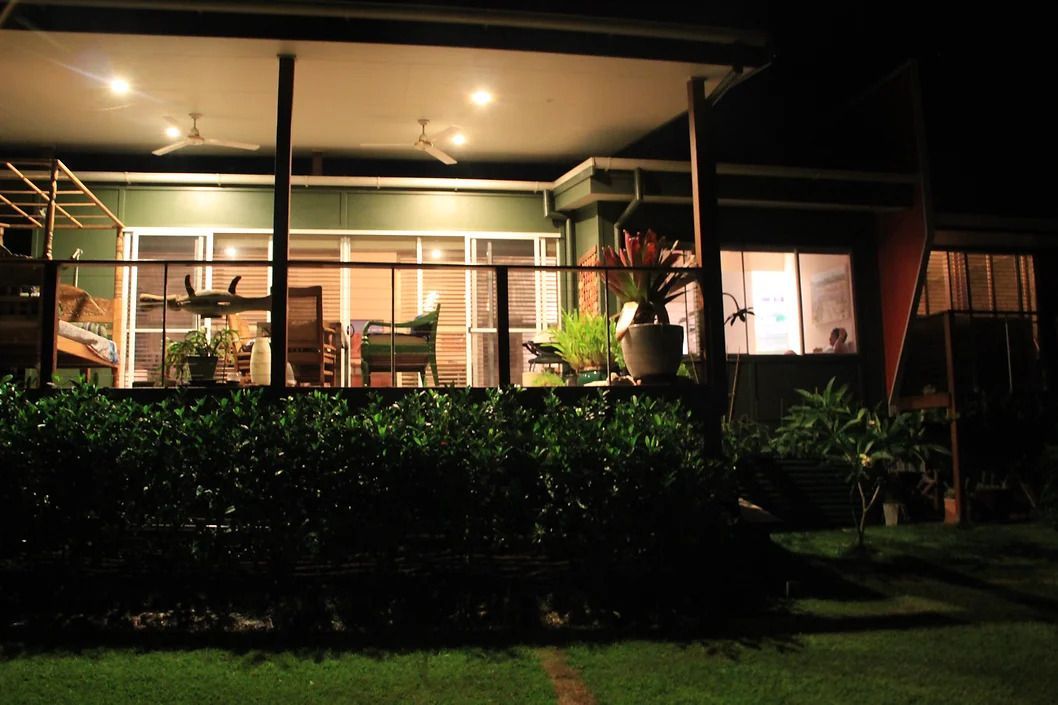 A House is Lit Up at Night With a Large Deck — D.J. Decks in Emerald Beach, NSW