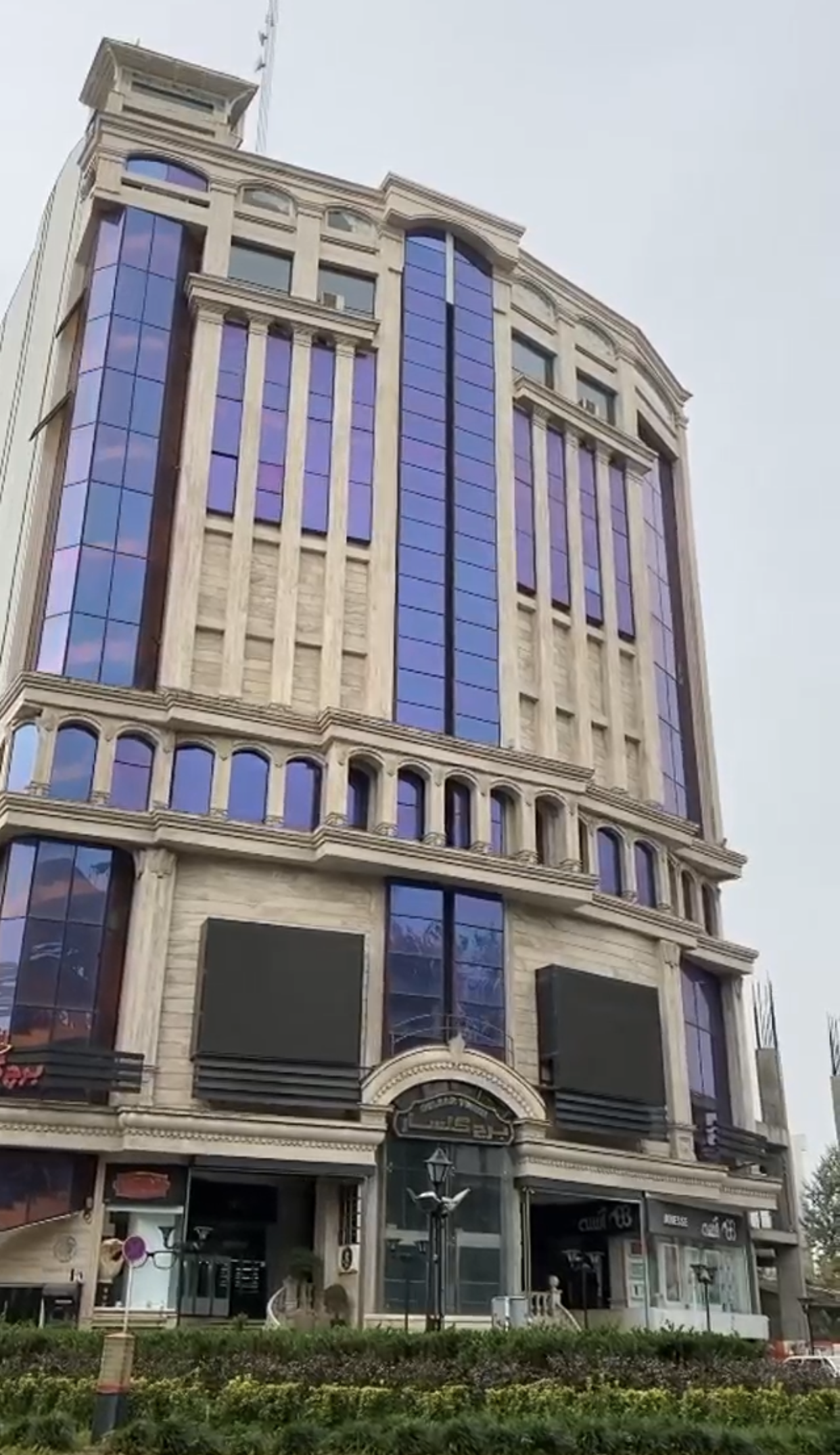 A large building with a lot of windows on a cloudy day.