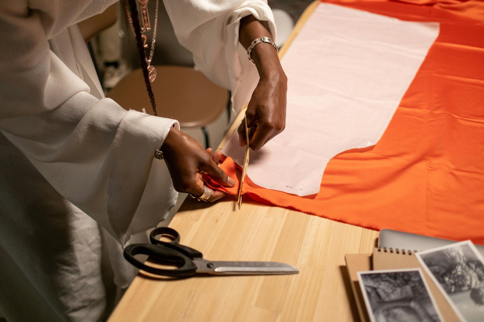A person is cutting a piece of fabric with scissors.