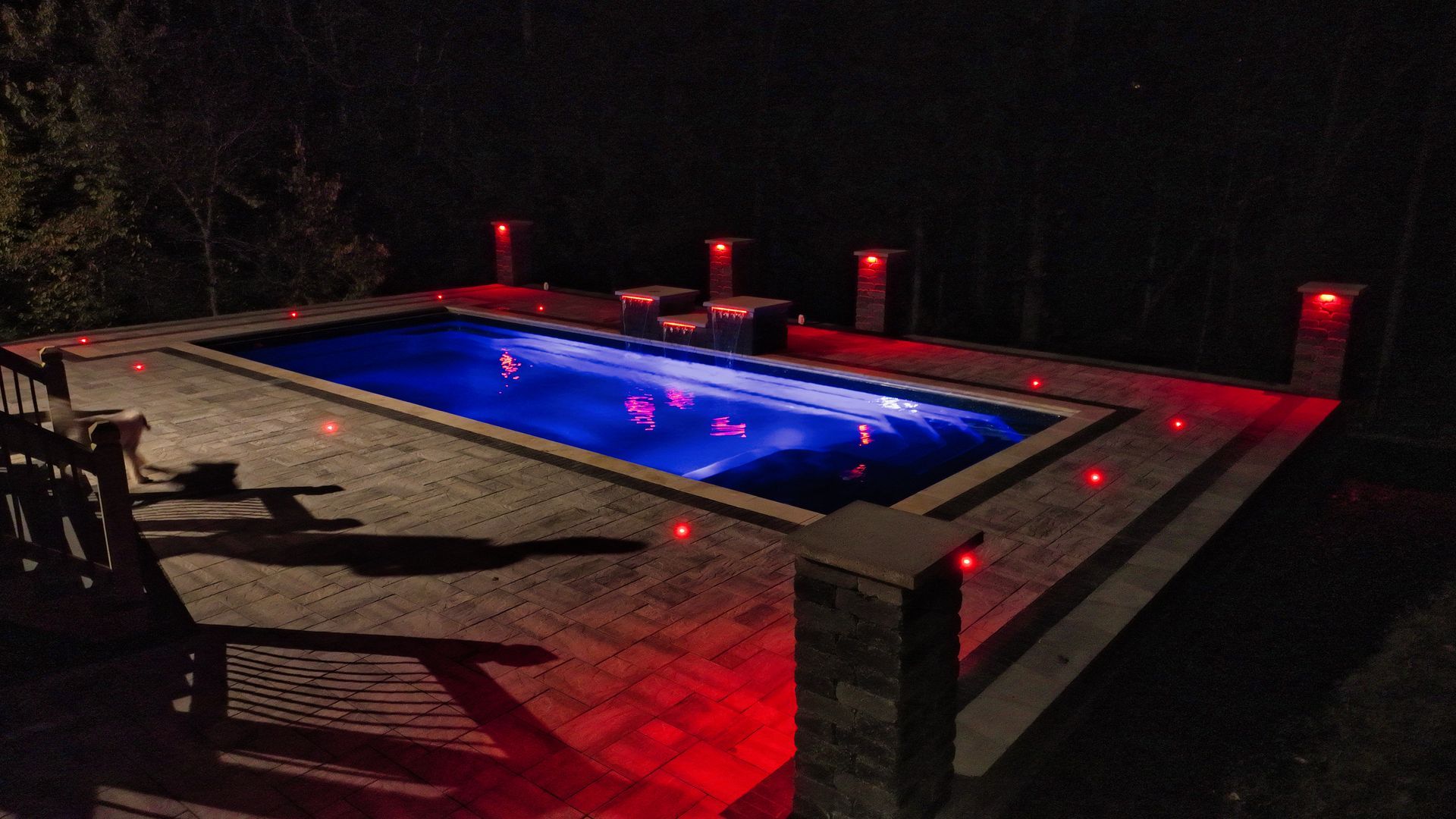 A stone walkway with stairs leading up to a house.