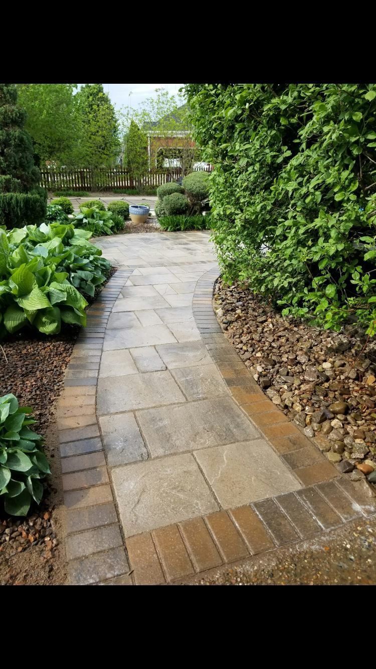 A stone walkway with stairs leading up to a house.