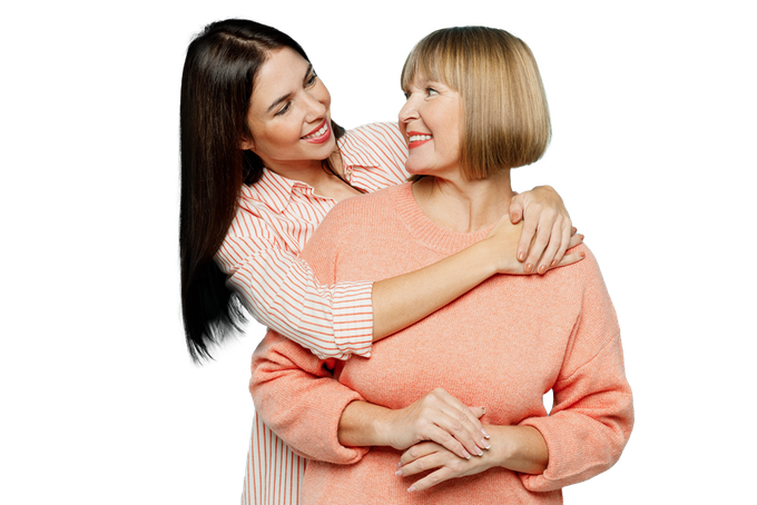 A young woman is hugging an older woman on a white background.