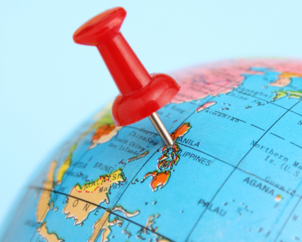 Red pushpin in a globe, marking the Philippines.