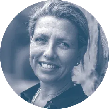 Kedge in a black shirt and pearls is smiling in a blue circle.