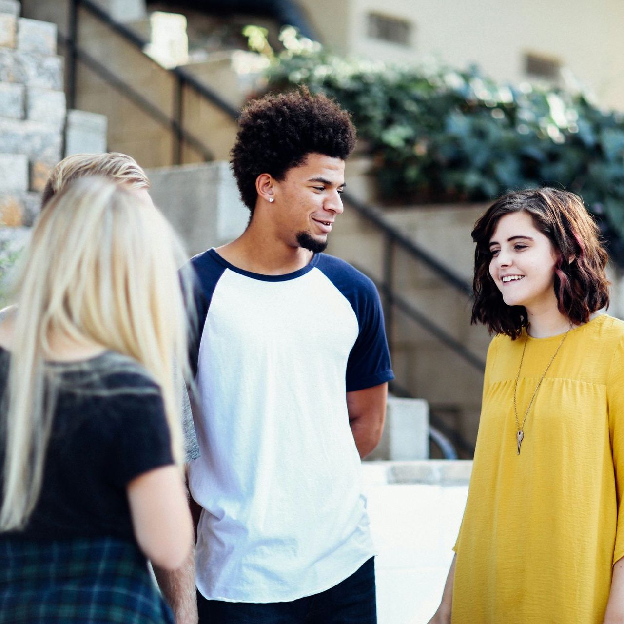 A group of people are standing next to each other and talking