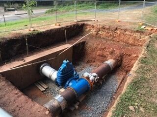 A Pipe Is Being Installed in A Hole in The Ground — Terranovus Earthworks & Plant Hire in Cairns, QLD