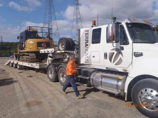 A Man Is Walking Next to A Truck that Says Terra Nova on The Side — Terranovus Earthworks & Plant Hire in Cairns, QLD