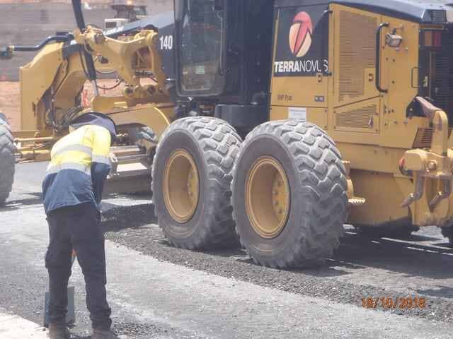 A Man Is Standing in Front of A Tractor that Says Terranova — Terranovus Earthworks & Plant Hire in Cairns, QLD