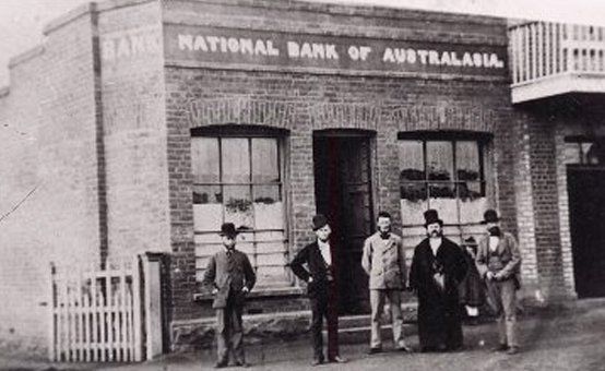 Five Men at the front of Old National bank building