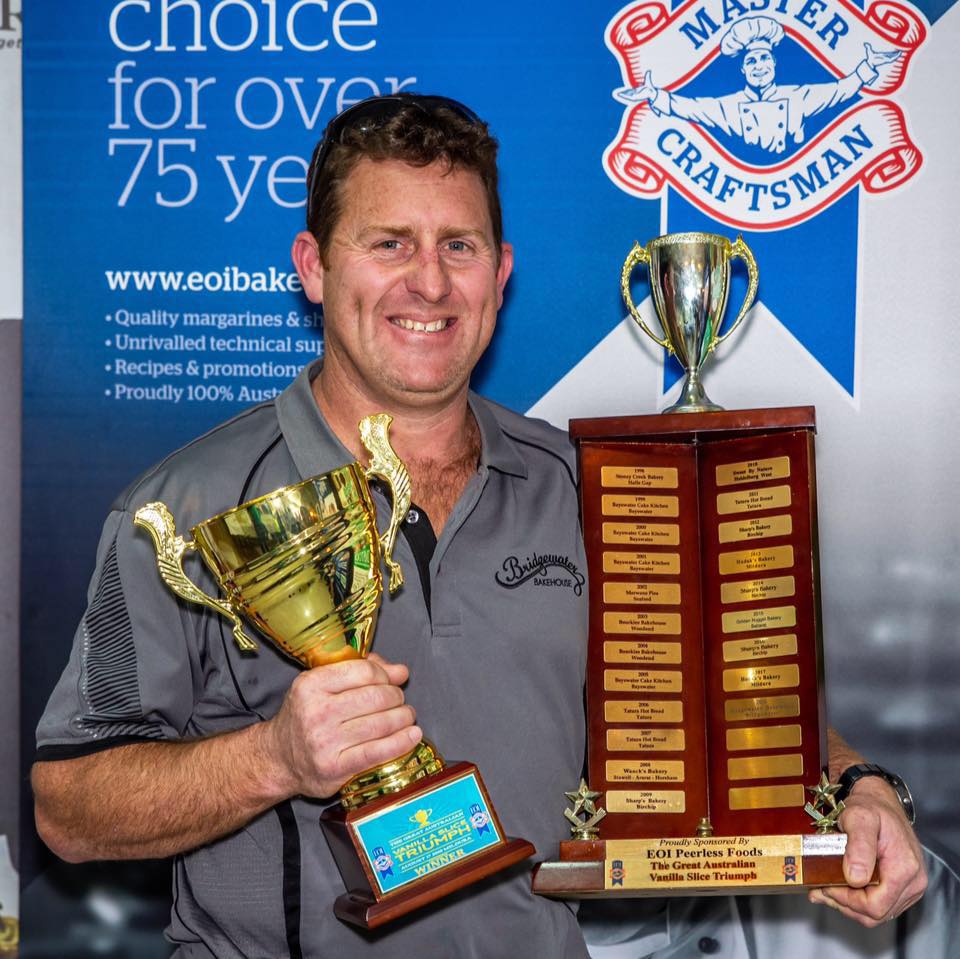 Man Holding two trophies