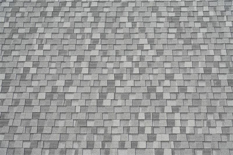 Gray asphalt shingle roof, close-up view.