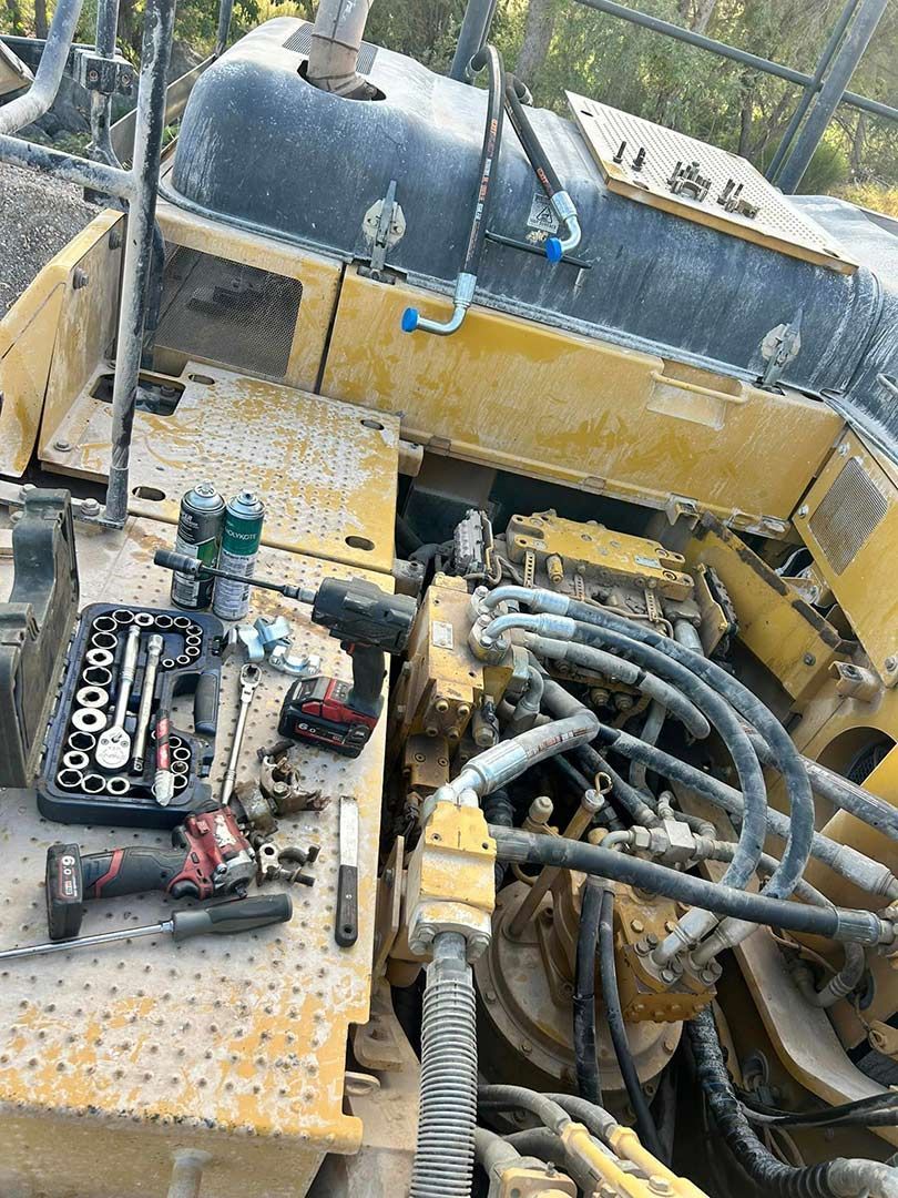 A Yellow And Black Machine Is Installed On Top Of A Table With Tools On It — Townsville Hydraulics In Garbutt, QLD