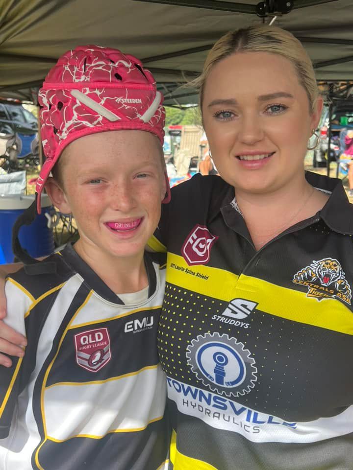 A Woman And A Boy Are Posing For A Picture. The Boy Is Wearing A Red Helmet — Townsville Hydraulics In Garbutt, QLD