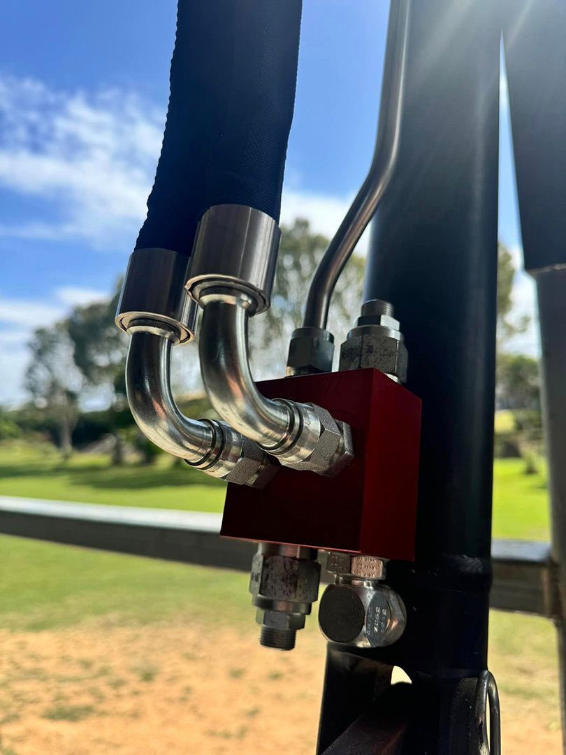 A Close Up Of A Hydraulic Hose Attached To A Pole — Townsville Hydraulics In Garbutt, QLD