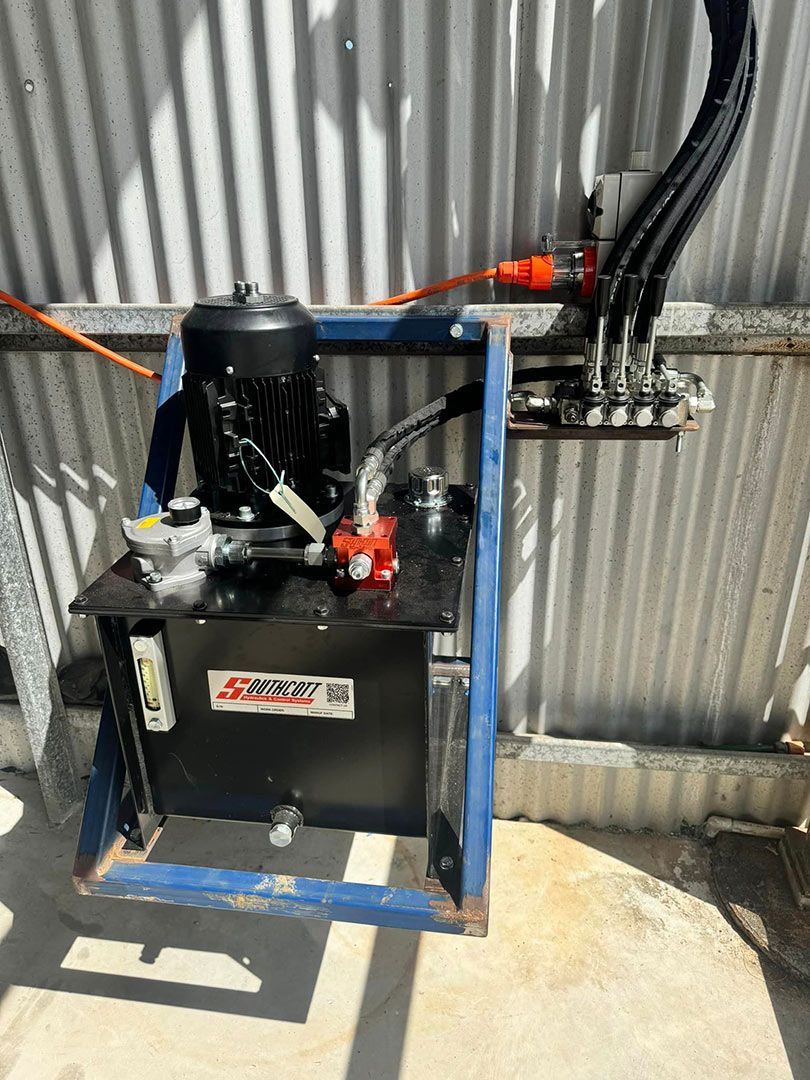A Hydraulic Pump Is Attached To A Metal Wall — Townsville Hydraulics In Garbutt, QLD