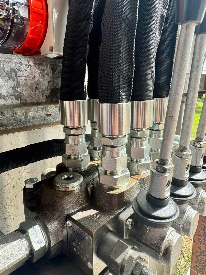 A Close Up Of A Bunch Of Hydraulic Hoses And Valves On A Machine — Townsville Hydraulics In Garbutt, QLD