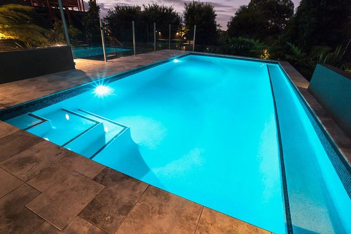a swimming pool with lighting