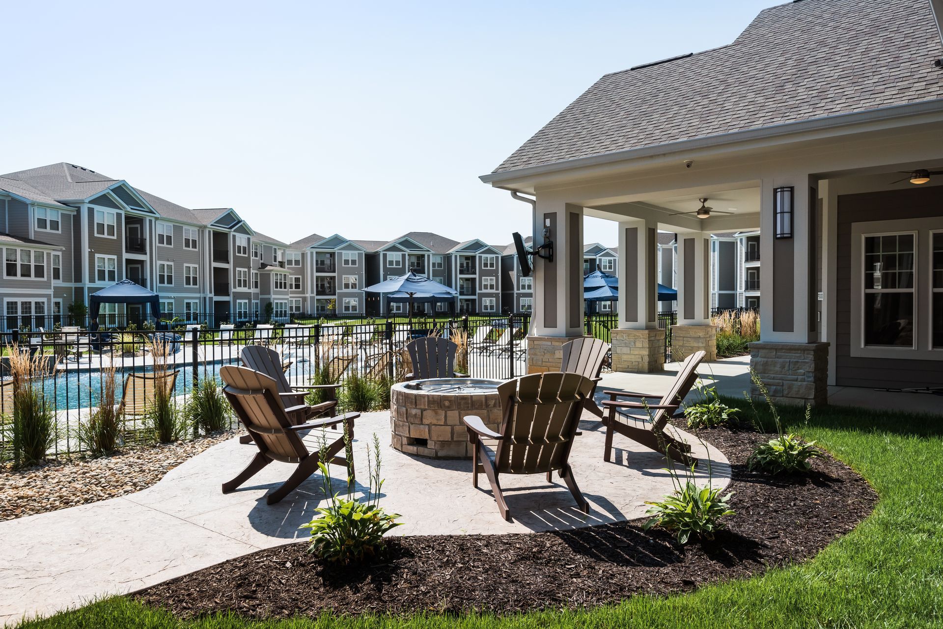 Dark kitchen with stainless steel appliances, dark cabinets, and a white countertop.