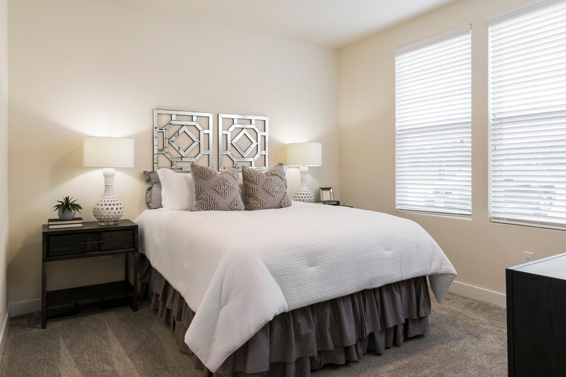 Bedroom with bed, nightstands, lamps, window with blinds, and headboard.
