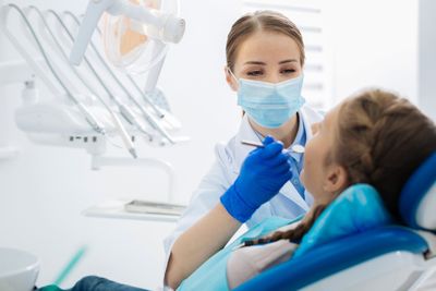 Bad Breath Treatment — Female Dentist at Work in Pine Bluff, AR