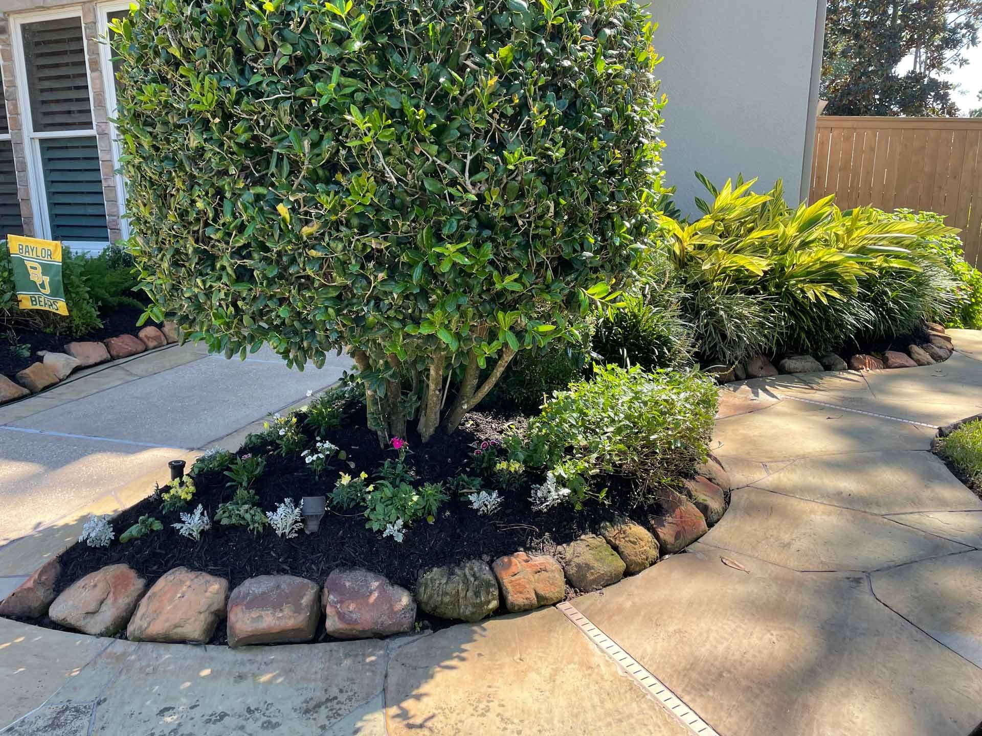 Garden Next To A Sidewalk — Houston, TX — B.E Lawn Services