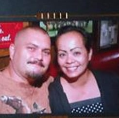 two people posing in front of a camera