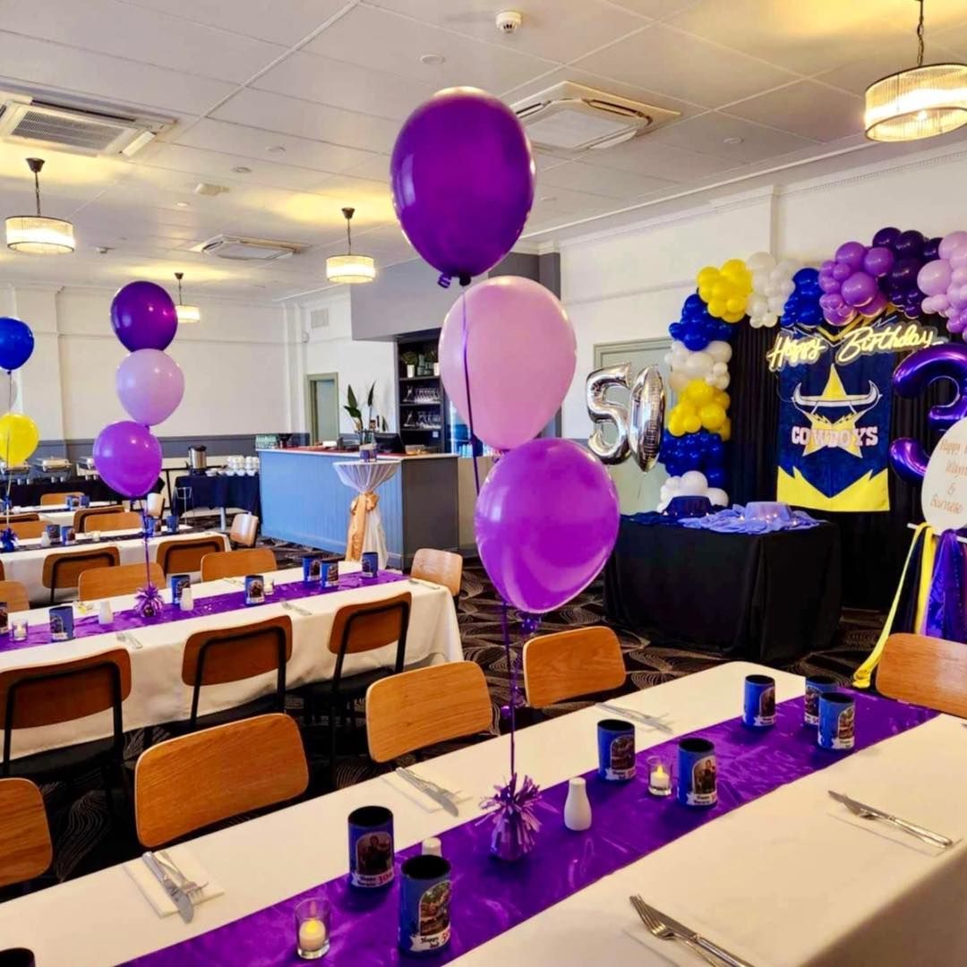 Event Room Decorated With Purple and Yellow Balloons and Table Settings — Creative Events Innisfail in Innisfail, QLD