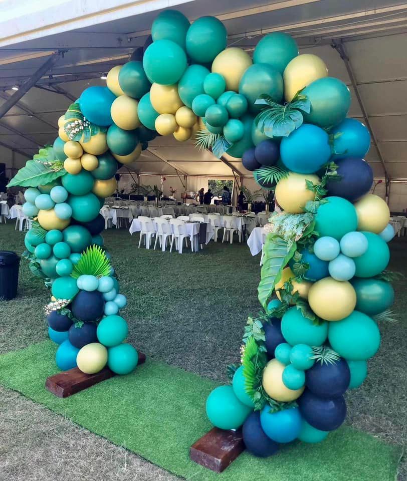 Balloon Arch in Shades of Green, Yellow, and Blue, Decorated With Leaves — Creative Events Innisfail in Innisfail, QLD
