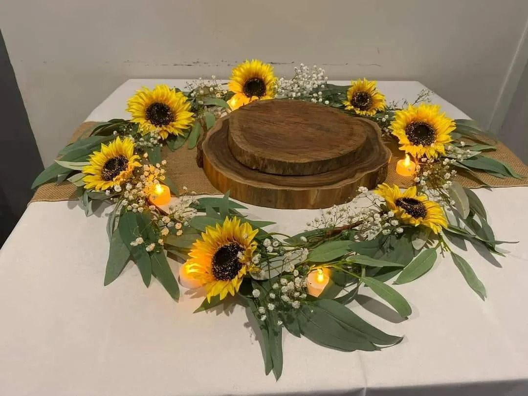 Sunflower Centerpiece on a White Tablecloth — Creative Events Innisfail in Innisfail, QLD
